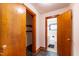 Hallway view of bathroom with black tile flooring and standard fixtures through closet openings at 412 Suburb St, Rocky Mount, NC 27801