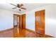 Bedroom with hardwood floors and a ceiling fan, featuring multiple closets and interior doors at 412 Suburb St, Rocky Mount, NC 27801