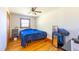 Modest bedroom with wood floors, a window, and standard furnishings including bed and shelving at 412 Suburb St, Rocky Mount, NC 27801