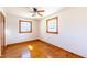 Cozy bedroom featuring hardwood floors, a ceiling fan, and natural light from two windows at 412 Suburb St, Rocky Mount, NC 27801