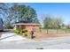 Charming single-story brick home with a well-manicured lawn and mature trees on a sunny day at 412 Suburb St, Rocky Mount, NC 27801
