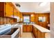 Cozy kitchen showcasing wood paneling, white appliances, and light countertops at 412 Suburb St, Rocky Mount, NC 27801