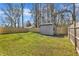 Backyard with green grass and a shed behind wood fence at 43 Nordan St, Angier, NC 27501