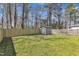 Backyard with a shed, green grass and wood fence at 43 Nordan St, Angier, NC 27501