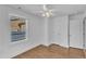 Cozy bedroom features wood-look floors, a ceiling fan, and a window offering a pleasant view of the outdoors at 43 Nordan St, Angier, NC 27501