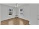 Bright bedroom featuring wood-look floors, two windows, and a ceiling fan providing comfort at 43 Nordan St, Angier, NC 27501