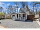 Quaint one-story home features white siding, dark shutters, and a welcoming front porch at 43 Nordan St, Angier, NC 27501