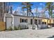 Side view of cozy house with white siding, wooden shutters, and a charming covered porch at 43 Nordan St, Angier, NC 27501