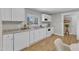 Contemporary kitchen design with white appliances and a large window overlooking the outdoor scenery and natural light at 43 Nordan St, Angier, NC 27501