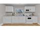 Bright kitchen showcases ample cabinetry, sleek countertops, and a window offering natural light and a pleasant view at 43 Nordan St, Angier, NC 27501