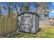 A well-maintained gray storage shed stands in the fenced backyard at 43 Nordan St, Angier, NC 27501