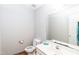 Well-lit half bath with vanity, sink, toilet and large mirror at 4324 Old Lewis Farm Rd, Raleigh, NC 27604