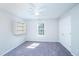 Neutral bedroom featuring large window, closet, and built-in shelves at 4324 Old Lewis Farm Rd, Raleigh, NC 27604