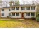 Traditional two-story home with a vibrant red front door and neatly kept lawn and mature landscaping at 4324 Old Lewis Farm Rd, Raleigh, NC 27604