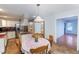 Eat-in kitchen features stainless steel appliances, tile flooring and wooden table with 4 chairs at 4324 Old Lewis Farm Rd, Raleigh, NC 27604