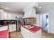 Kitchen with large island, custom cabinets, and stainless steel appliances at 4324 Old Lewis Farm Rd, Raleigh, NC 27604