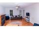 Living room with hardwood floors, ceiling fan, and a fireplace at 4324 Old Lewis Farm Rd, Raleigh, NC 27604