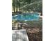 In ground pool surrounded by a mature tree line and wooded area at 4324 Old Lewis Farm Rd, Raleigh, NC 27604