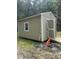 Yard shed with open door on a lot with grass and woods in the background at 4324 Old Lewis Farm Rd, Raleigh, NC 27604
