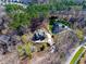 An aerial view of a home surrounded by lush greenery, revealing its architectural layout and secluded location at 4721 Cypress Ford Dr, Fuquay Varina, NC 27526