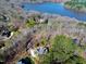 Aerial view of a home near the water, highlighting its spacious lot and proximity to the lake at 4721 Cypress Ford Dr, Fuquay Varina, NC 27526