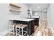 Contemporary bar area with quartz countertops, stylish seating, and open shelving at 4721 Cypress Ford Dr, Fuquay Varina, NC 27526