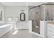 Bright bathroom featuring walk-in shower, soaking tub, double vanity and modern finishes at 4721 Cypress Ford Dr, Fuquay Varina, NC 27526