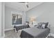 This bright bedroom features two beds, side table, and a large window overlooking the backyard at 4721 Cypress Ford Dr, Fuquay Varina, NC 27526