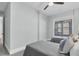 This bright bedroom features two beds and a large window overlooking the backyard at 4721 Cypress Ford Dr, Fuquay Varina, NC 27526