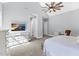 Bright bedroom with vaulted ceilings, a ceiling fan, and a dresser with a television on top at 4721 Cypress Ford Dr, Fuquay Varina, NC 27526