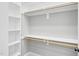 Walk-in closet featuring built-in shelving and wooden closet rods at 4721 Cypress Ford Dr, Fuquay Varina, NC 27526