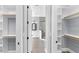 View through open closet doors to bathroom with glass shower, vanity and modern finishes at 4721 Cypress Ford Dr, Fuquay Varina, NC 27526