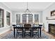 Dining room offers natural light, fireplace, traditional furnishings, and view of the yard at 4721 Cypress Ford Dr, Fuquay Varina, NC 27526