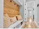 Cozy entryway with bench seating, wood paneling, and storage shelves at 4721 Cypress Ford Dr, Fuquay Varina, NC 27526