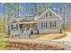 Charming two-story home with a welcoming front porch and well-manicured landscaping nestled in a beautiful wooded area at 4721 Cypress Ford Dr, Fuquay Varina, NC 27526