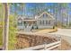 Charming two-story home with a welcoming front porch and well-manicured landscaping nestled in a beautiful wooded area at 4721 Cypress Ford Dr, Fuquay Varina, NC 27526