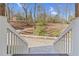 View from the front porch showcasing a long driveway leading into the street, all surrounded by a serene wooded area at 4721 Cypress Ford Dr, Fuquay Varina, NC 27526