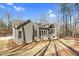 This home has an outdoor porch, gray siding, well manicured yard, and mature trees at 4721 Cypress Ford Dr, Fuquay Varina, NC 27526