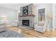 Cozy living room features a stone fireplace with a wooden mantel and hearth at 4721 Cypress Ford Dr, Fuquay Varina, NC 27526