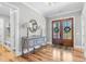 Elegant foyer featuring hardwood floors and stylish console table with decor at 4721 Cypress Ford Dr, Fuquay Varina, NC 27526