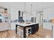 Modern kitchen boasts a large island, stainless appliances, and custom cabinetry at 4721 Cypress Ford Dr, Fuquay Varina, NC 27526