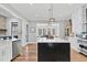 Gourmet kitchen featuring a large island, stainless steel appliances, and a view of the dining area at 4721 Cypress Ford Dr, Fuquay Varina, NC 27526