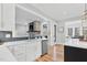 Kitchen with stone fireplace view, stainless steel appliances, and custom cabinets at 4721 Cypress Ford Dr, Fuquay Varina, NC 27526