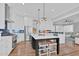 Stylish kitchen with a center island, white cabinets, stainless steel appliances, and hardwood floors at 4721 Cypress Ford Dr, Fuquay Varina, NC 27526
