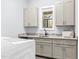 Well-lit laundry room with granite countertops and ample cabinet space at 4721 Cypress Ford Dr, Fuquay Varina, NC 27526
