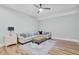 Comfortable living room with ceiling fan, hardwood floors and neutral decor provides a cozy retreat at 4721 Cypress Ford Dr, Fuquay Varina, NC 27526