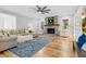 Spacious living room featuring a stone fireplace, hardwood floors, and natural light at 4721 Cypress Ford Dr, Fuquay Varina, NC 27526