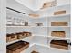 Spacious pantry with shelving containing labeled jars and wicker baskets at 4721 Cypress Ford Dr, Fuquay Varina, NC 27526