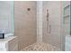 Shower featuring stone floors, gray tiled walls, bronze shower head and built-in shelves at 4721 Cypress Ford Dr, Fuquay Varina, NC 27526