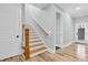 Bright staircase featuring wood railing, white risers and natural light at 4721 Cypress Ford Dr, Fuquay Varina, NC 27526